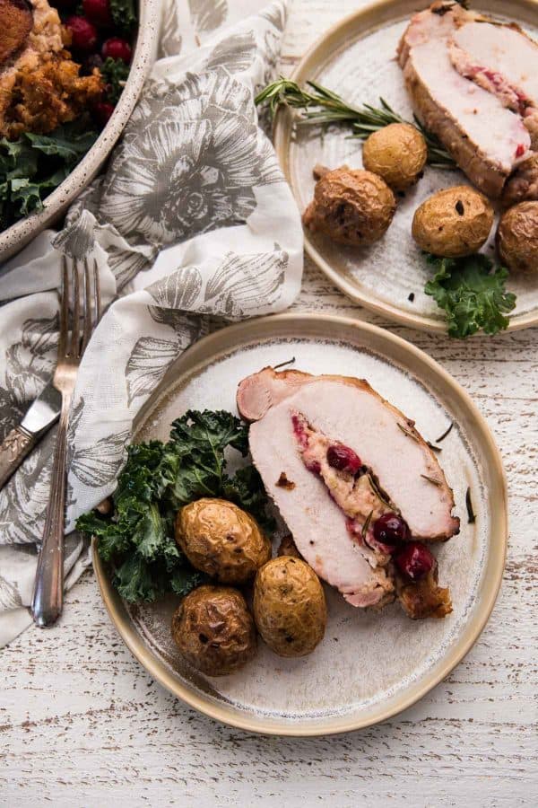 sliced pork on plates with vegetables