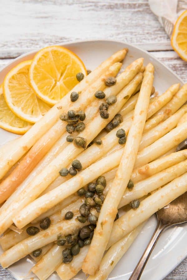 close up of piccata asparagus on a plate