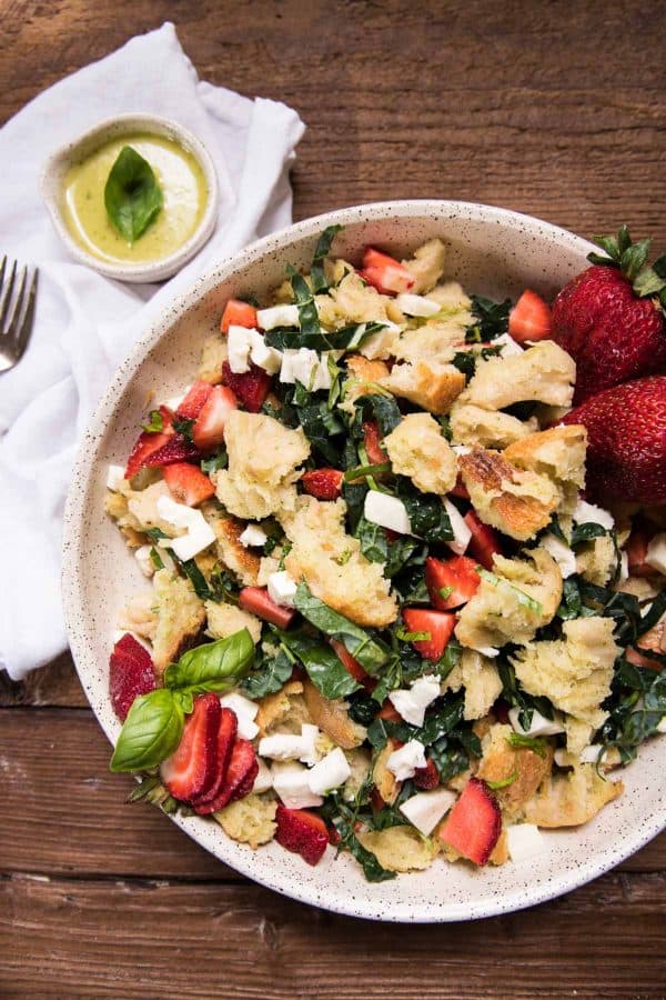 large platter with sourdough panzanella and a small ramekin of dressing