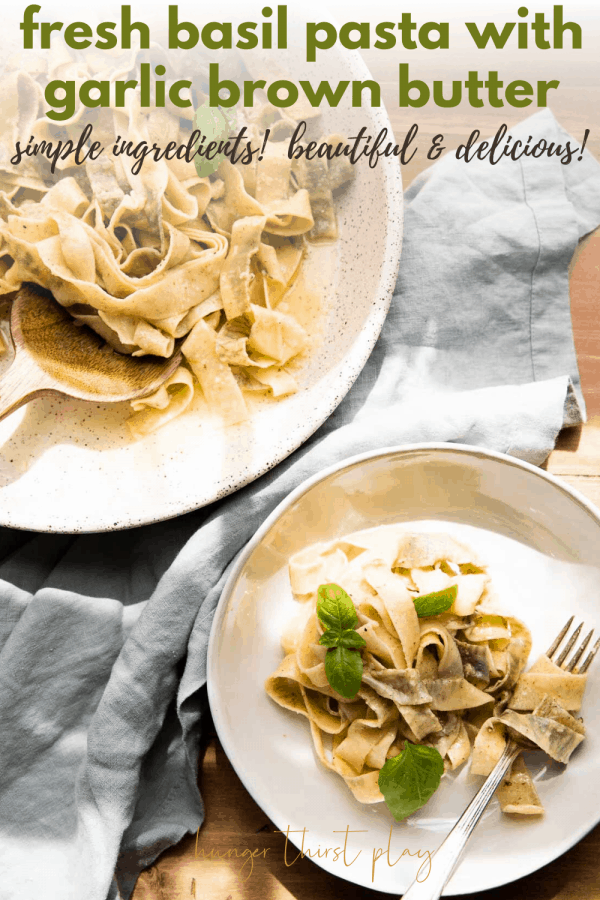 overhead close up of basil pappardelle wrapped around a fork and serving platter of pasta