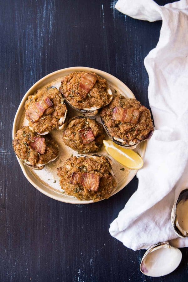 baked stuffed clams on a plate with fresh lemon