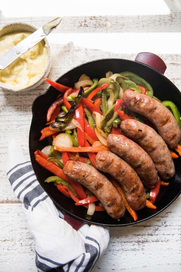 sausage and peppers in a cast iron skillet