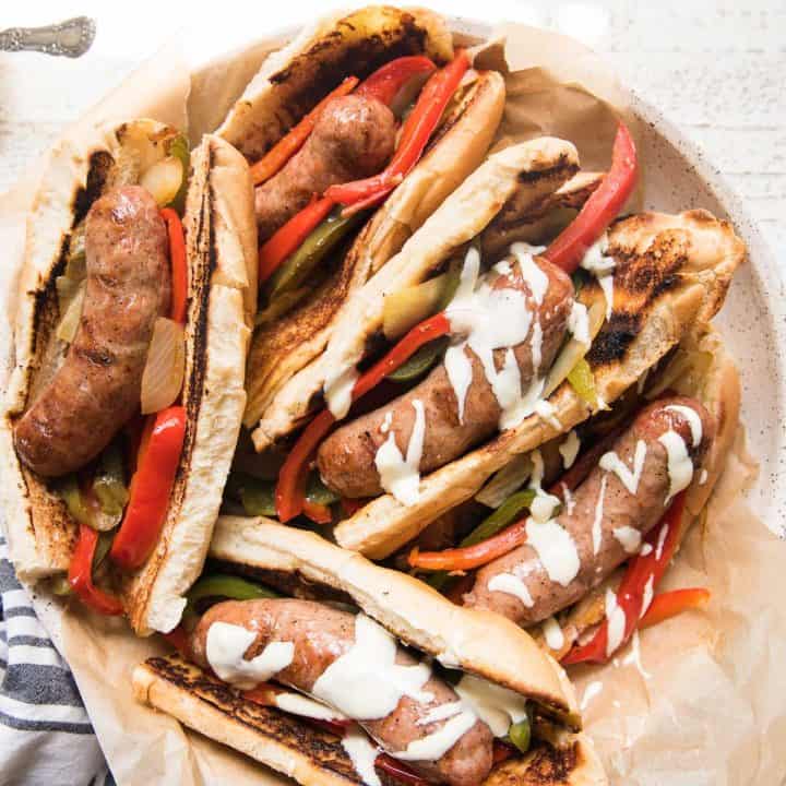 plate of sausage and peppers sandwiches