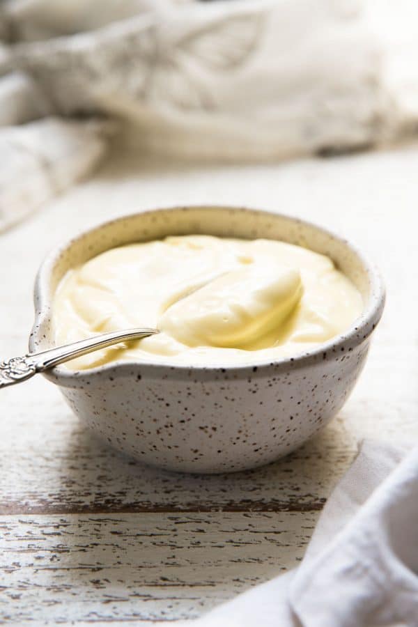 spoon scooping aioli out of a bowl