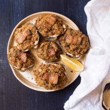 baked stuffed clams on a plate with fresh lemon