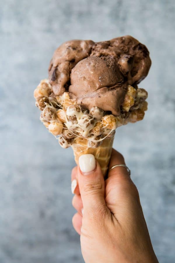 hand holding chocolate ice cream waffle cone