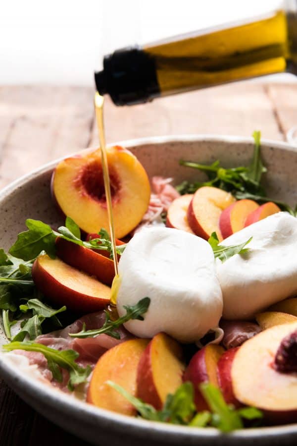 olive oil pouring over salad