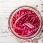 over head of pickled onions in a mason jar