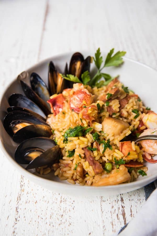 side angle of rice, lobster and mussels in a bowl