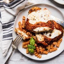 chicken parmesan over pasta on a plate