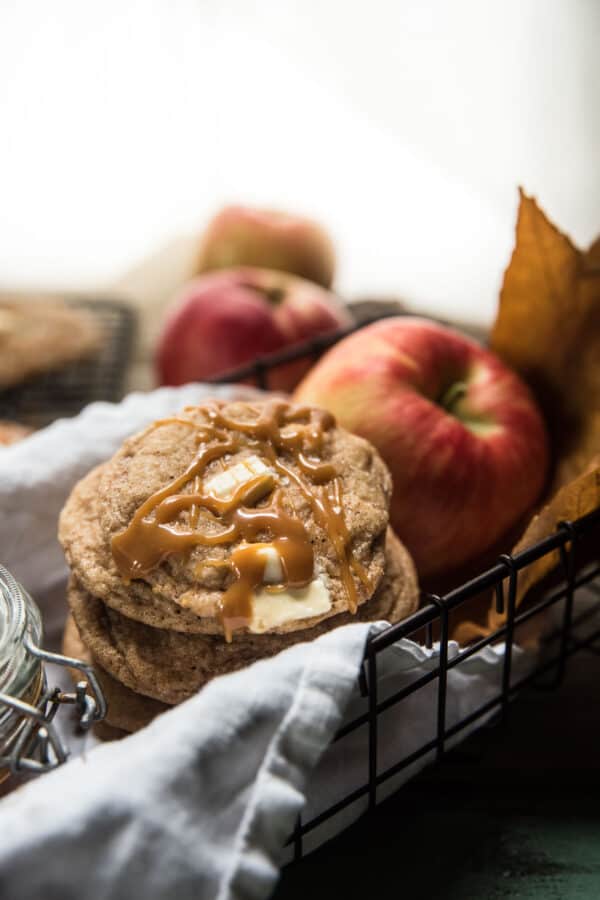 stacked cookies on linen napkin with apples