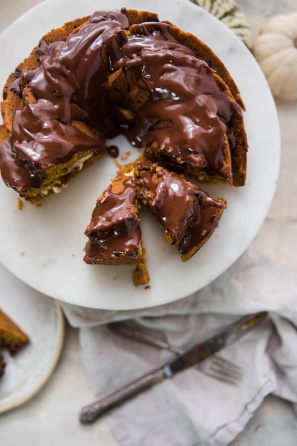 cut pieces of chocolate glaze bundt cake on a cake stand