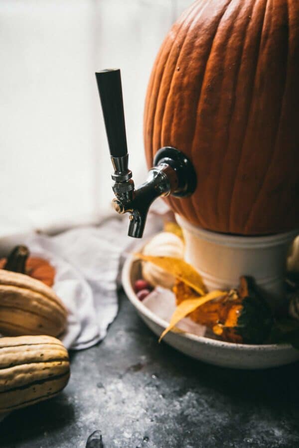 side angle of pumpkin with a drink dispenser tapped on it