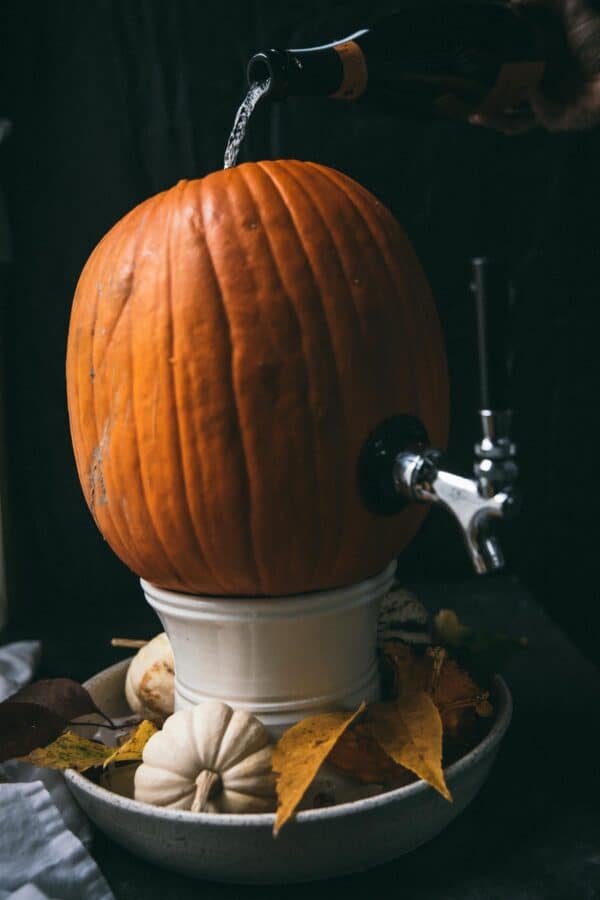 prosecco pouring into a pumpkin