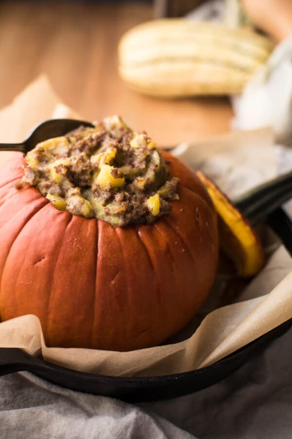 side angle of roasted pumpkin with savory stuffing