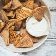 chip being dipped into vanilla cream dip