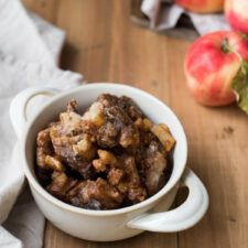 apple fritters stacked in a bowl