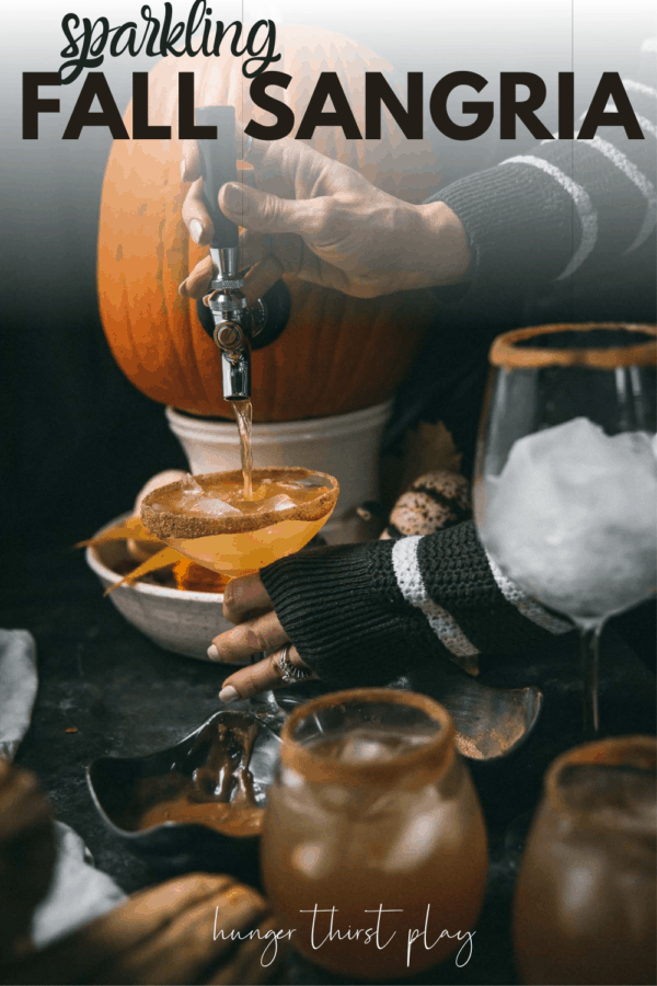pouring sangria out of a tapped pumpkin