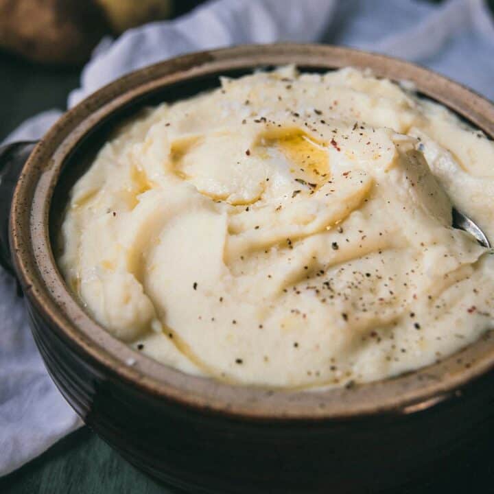 side angle of mashed potatoes in a ceramic crock
