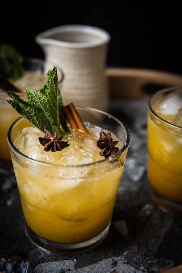 close up side angle of pumpkin whiskey smash in a rocks glass