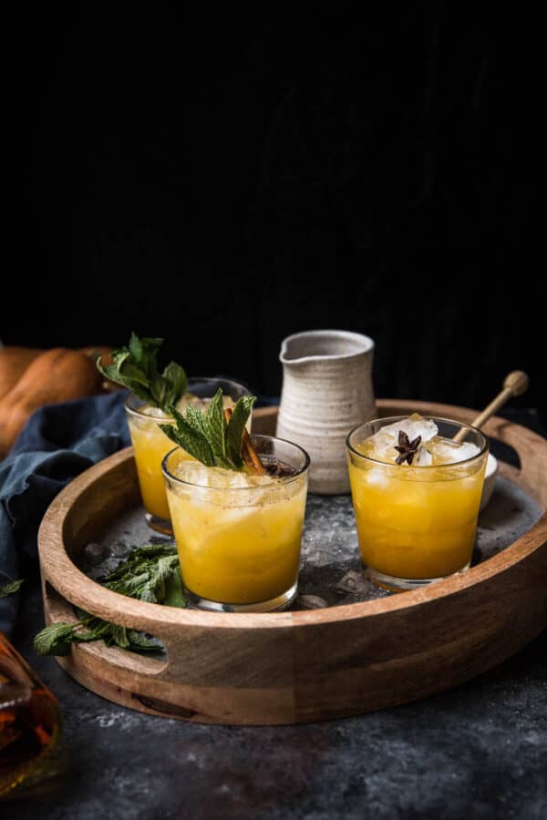 side angle of pumpkin smash cocktails on a drink tray