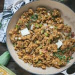 overhead of cornbread stuffing in a skillet with butter