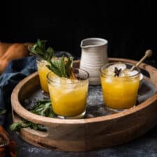 side angle of pumpkin smash cocktails on a drink tray