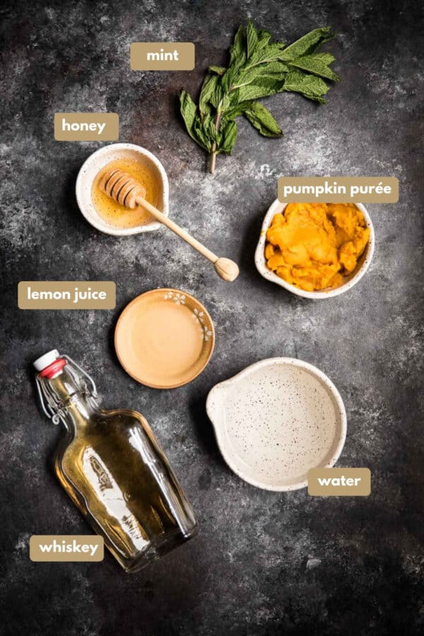 overhead photo of labeled ingredients for honey pumpkin whiskey smash