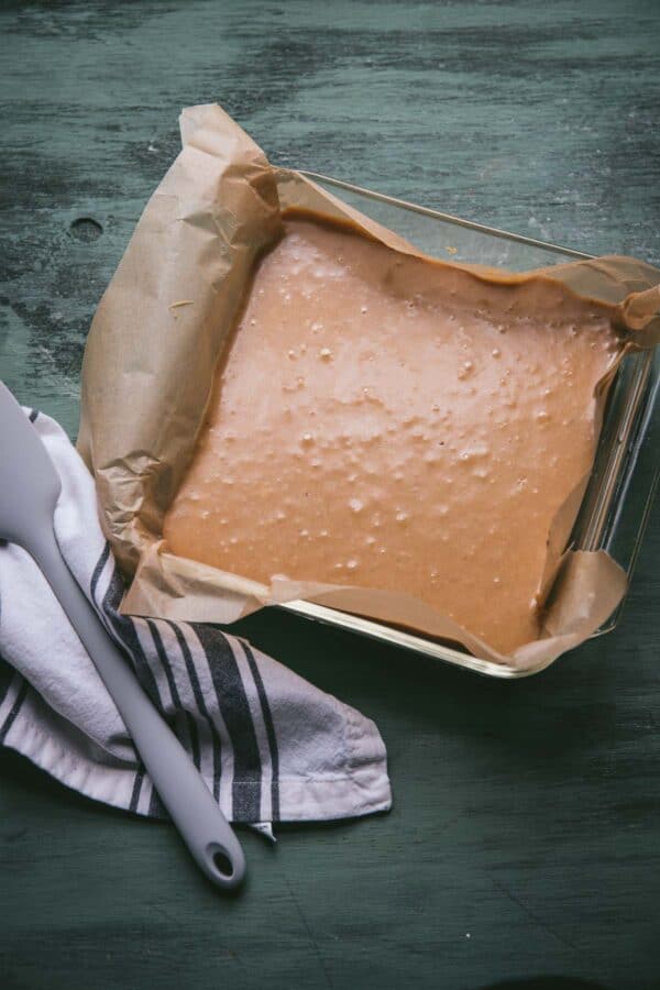 freshly made fudge poured into a parchment lined baking pan