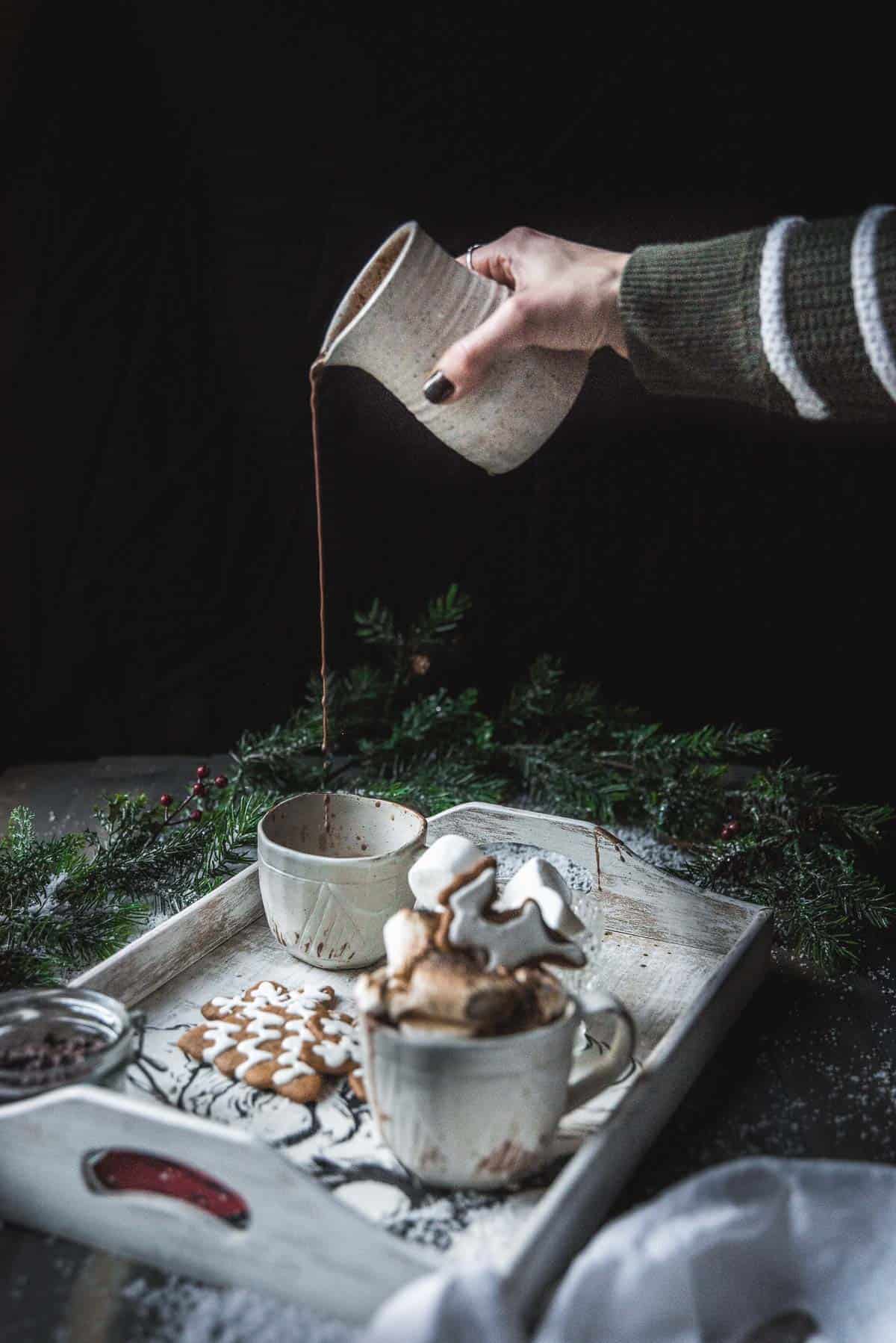 pouring hot chocolate into a cup