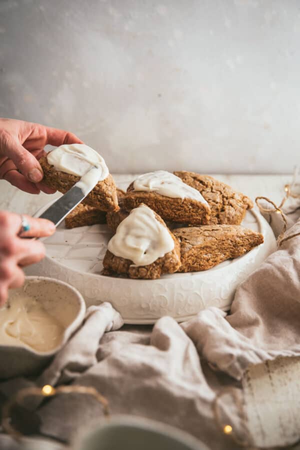 frosting scones over a platter