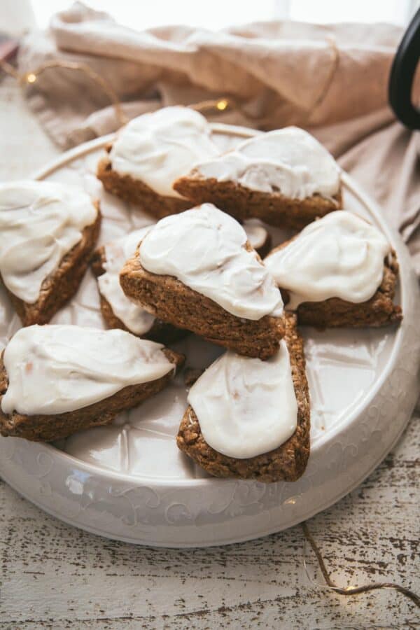 gingerbread scones with cream cheese frosting on a platter