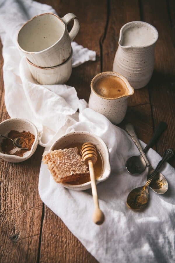 honey comb and honey stick in a bowl