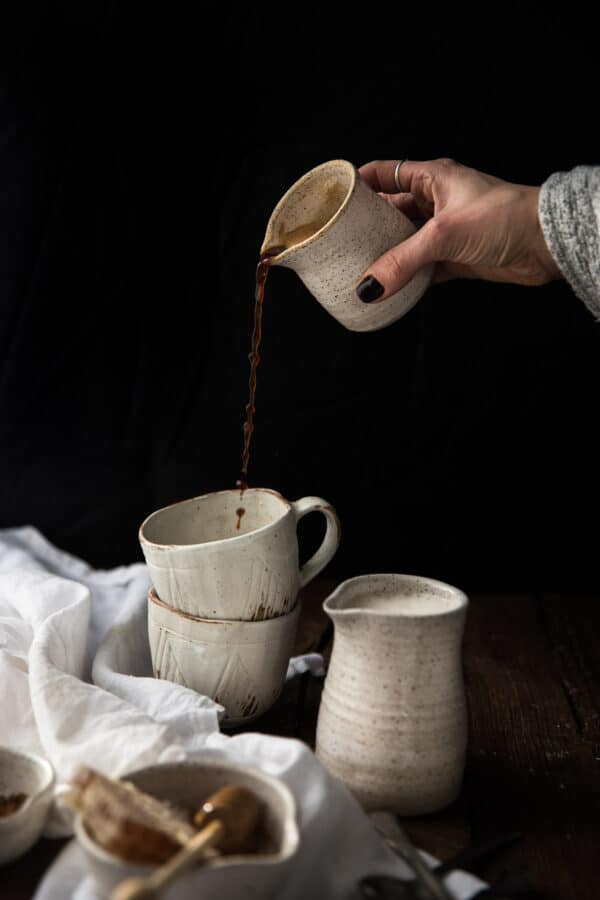 espresso pouring into stacked mugs