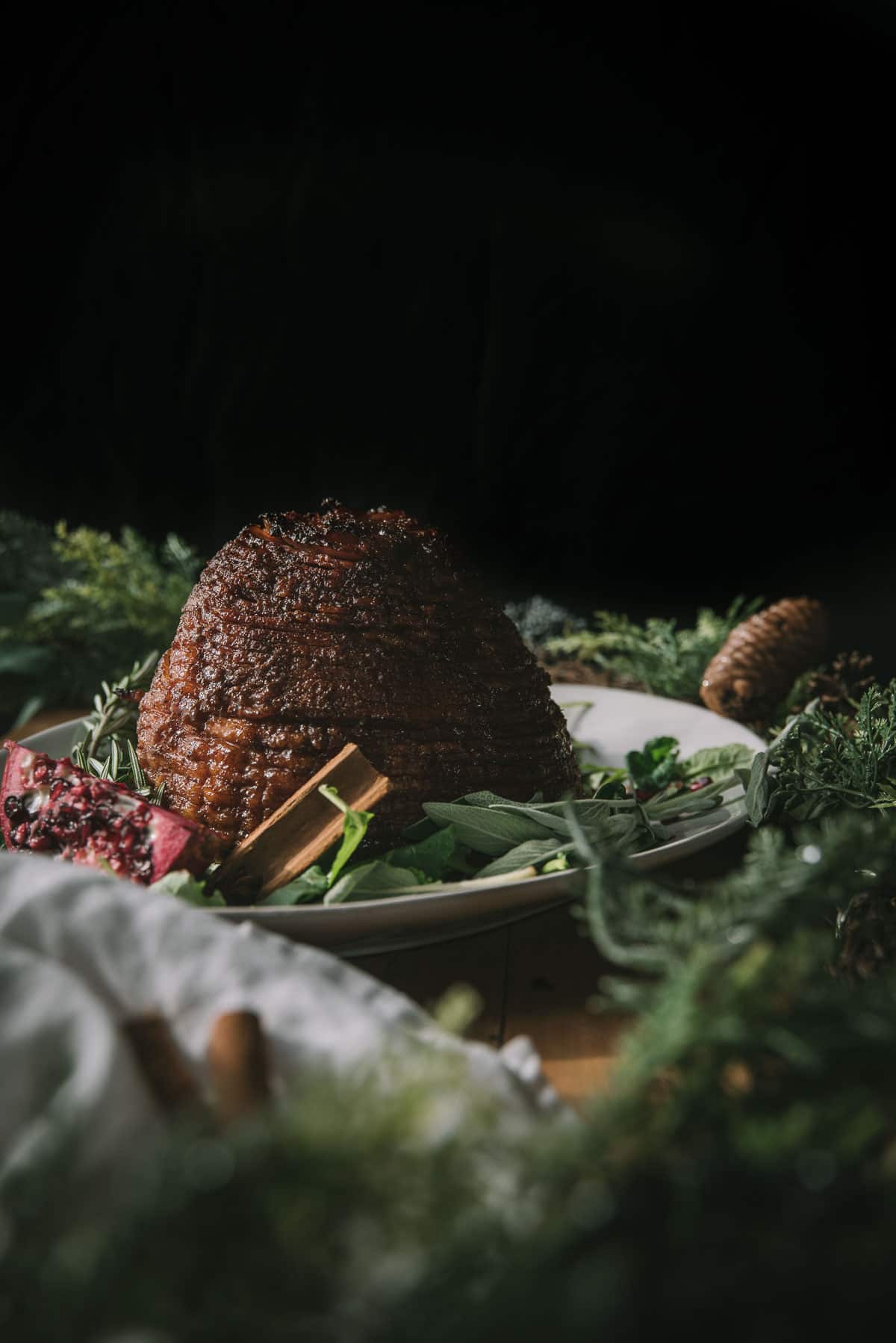 side angle of sugar glazed ham on a serving plate