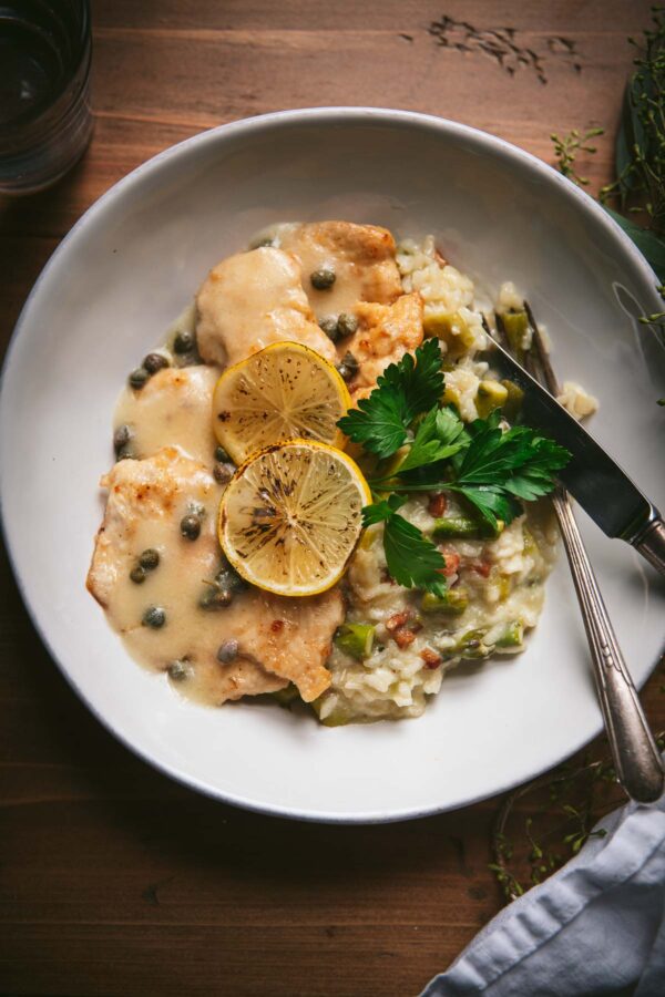 chicken piccata with broiled lemon wheels over asparagus risotto