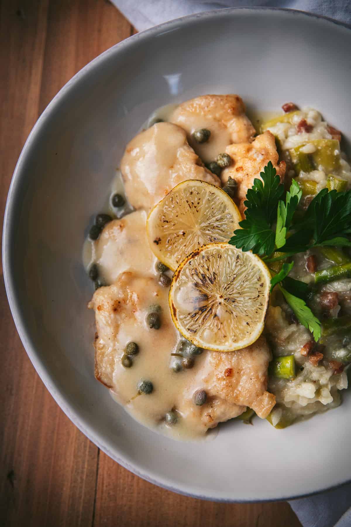 close up of chicken piccata and risotto 