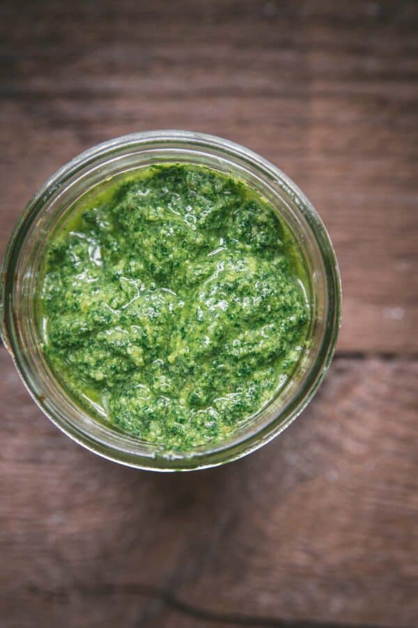 overhead of fresh kale pesto in a canning jar