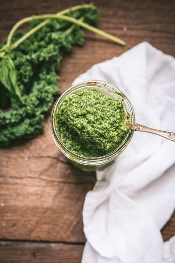 spoonful of pesto scooping it out of a canning jar