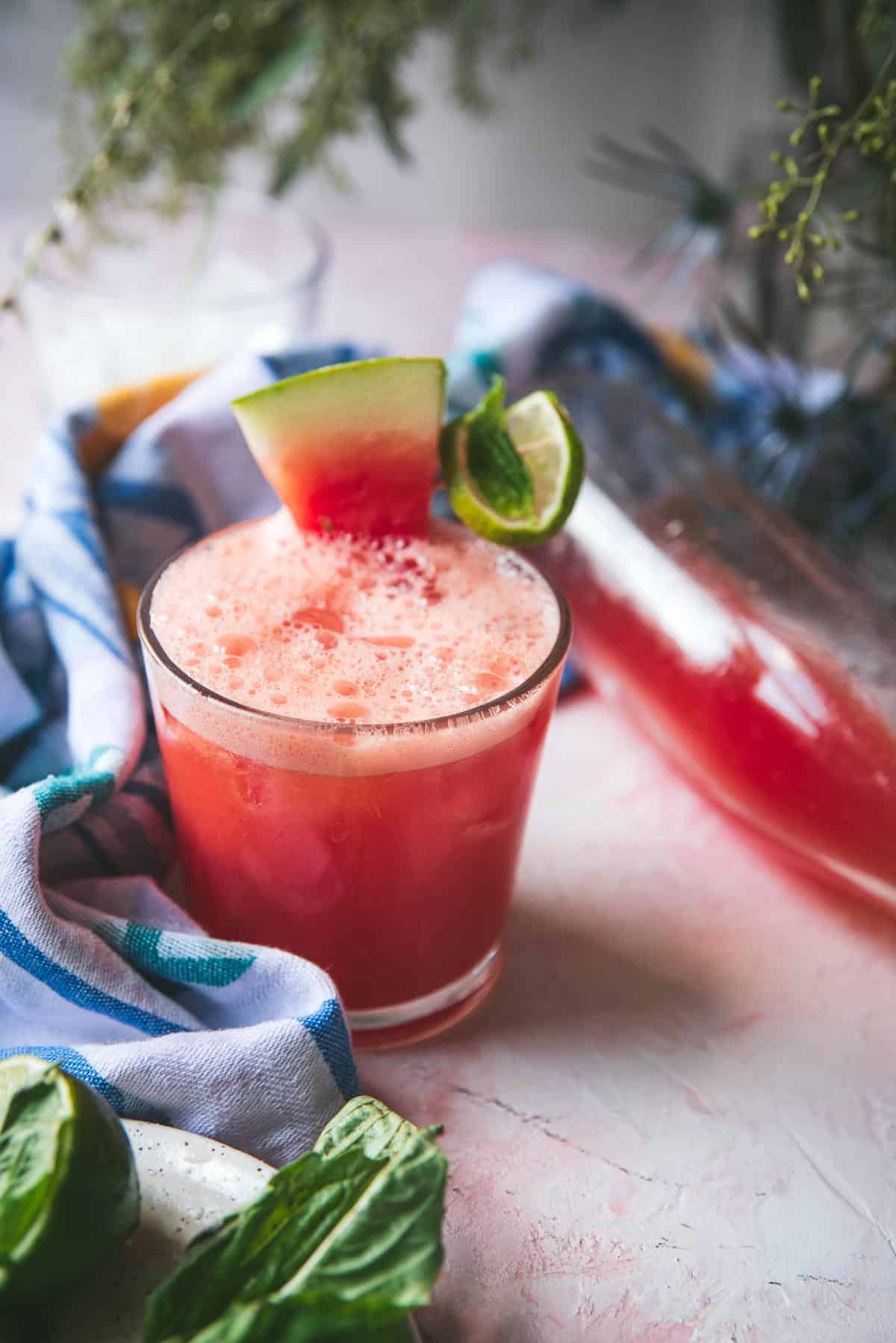 slice of watermelon on a glass of watermelon limeade