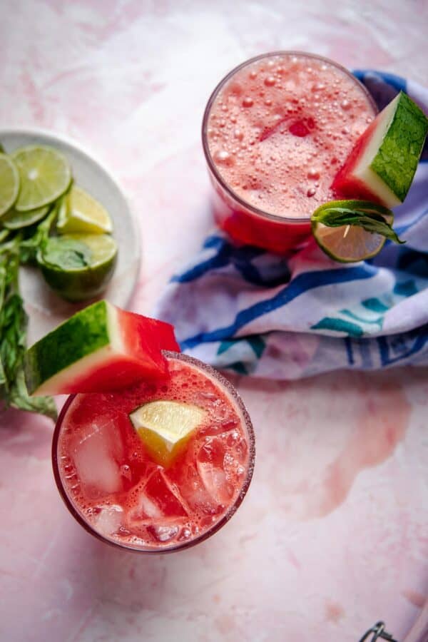 overhead of watermelon limeade in glasses with watermelon and lime garnish