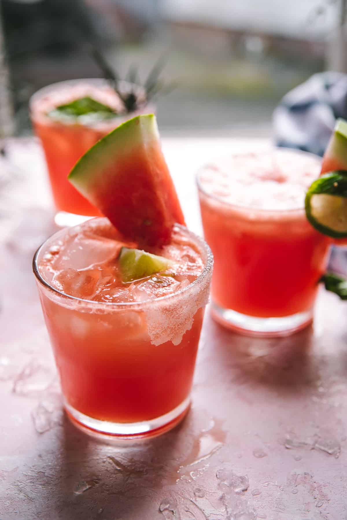 side angle of pink soda in a glass with ice