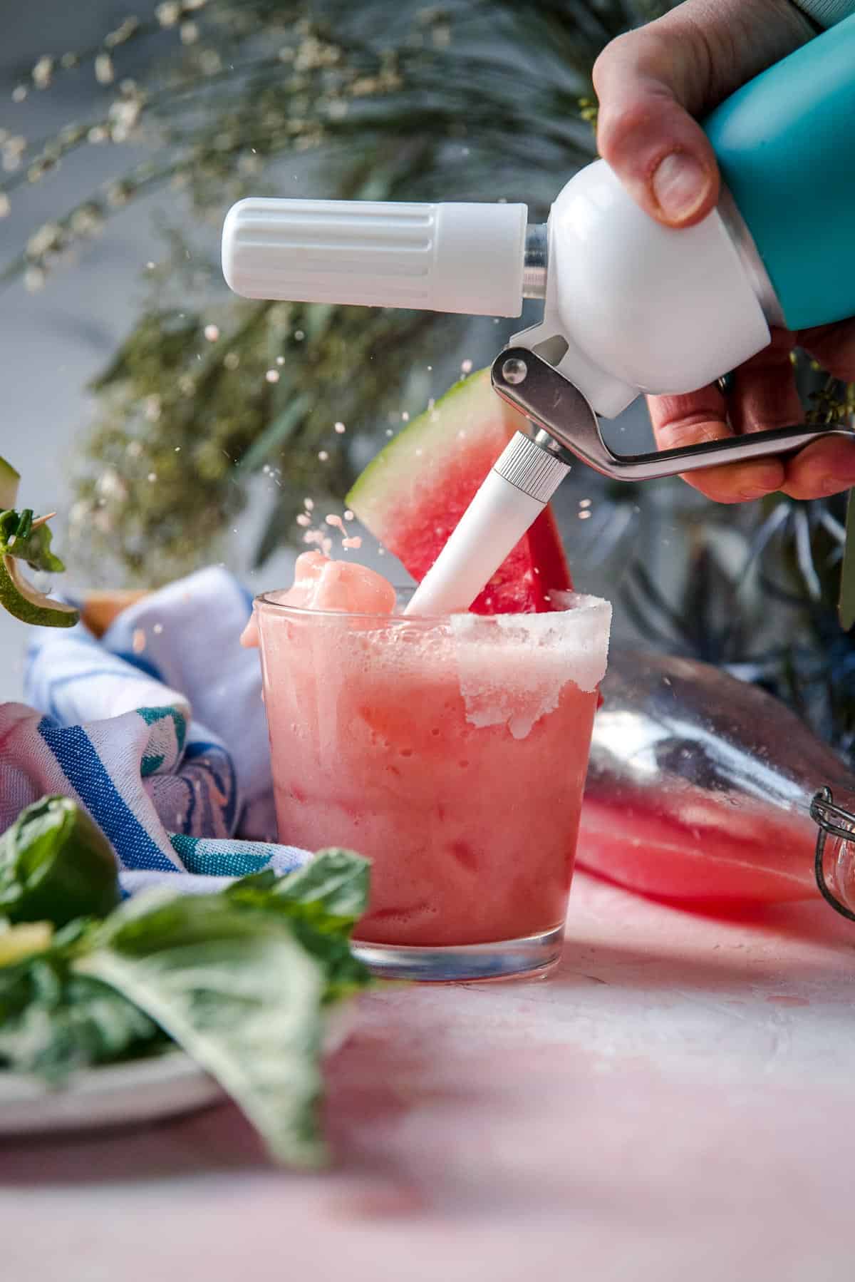 splashing homemade soda into a glass with ice