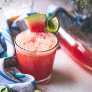 slice of watermelon on a glass of watermelon limeade