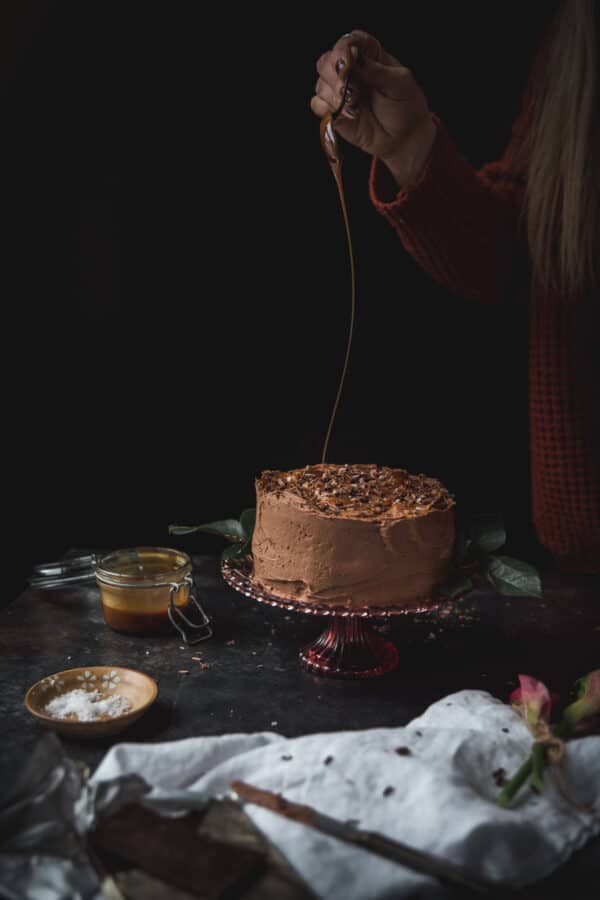 swirling chocolate over a cake