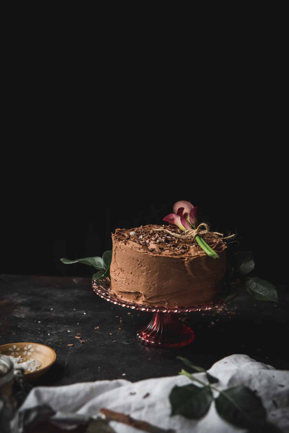 side angle of chocolate cake for two on a cake stand
