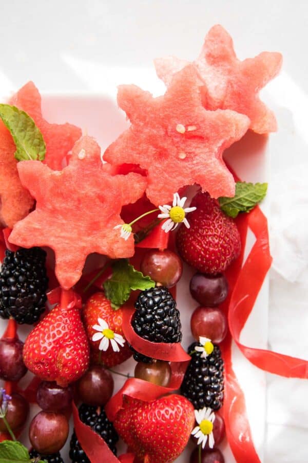 close up of star cut watermelon pieces on top of fruit wands
