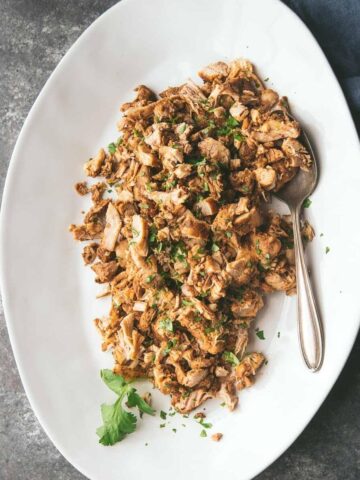 platter of chipotle chicken thighs with a spoon