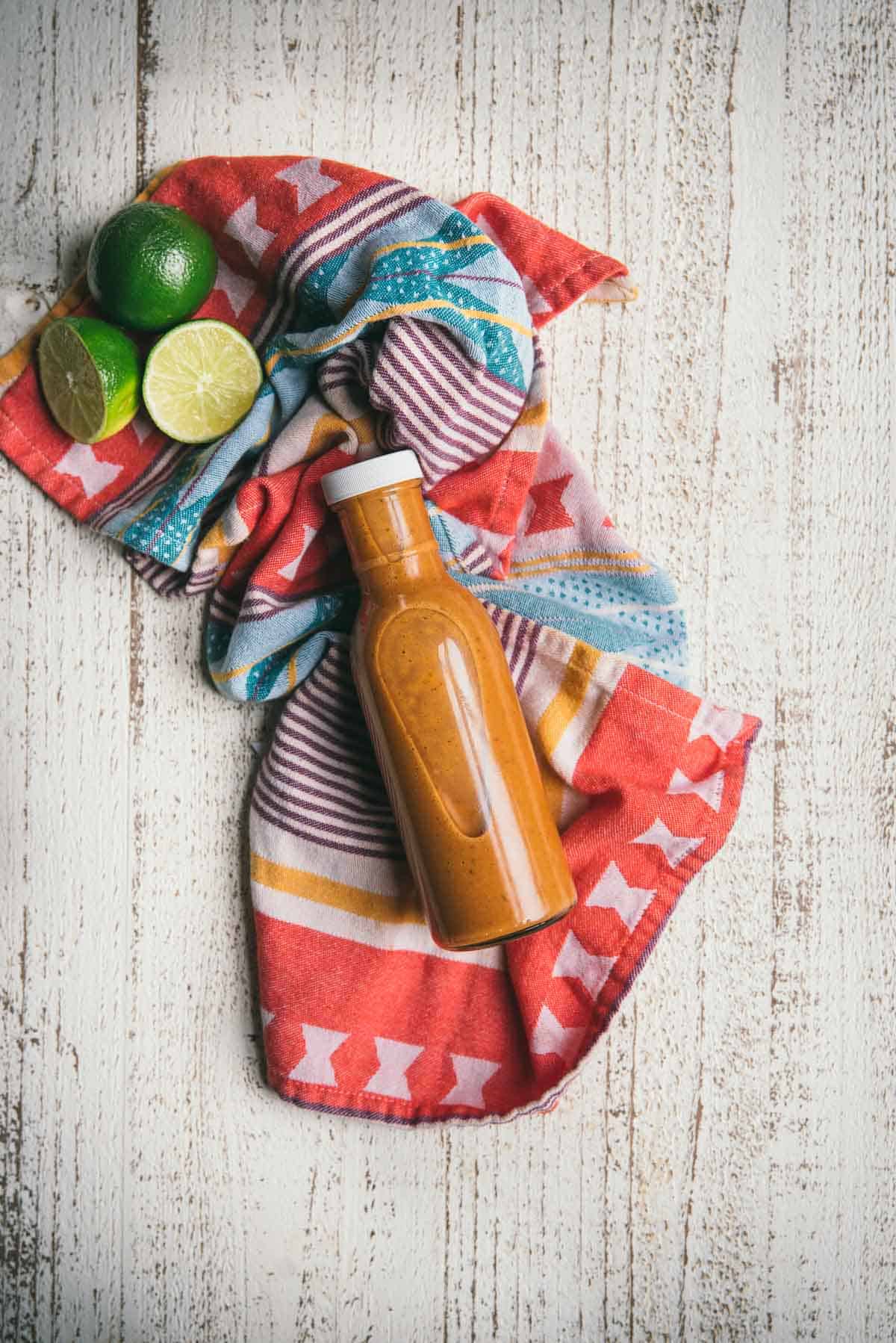 bottle of chipotle honey lime dressing on a color napkin