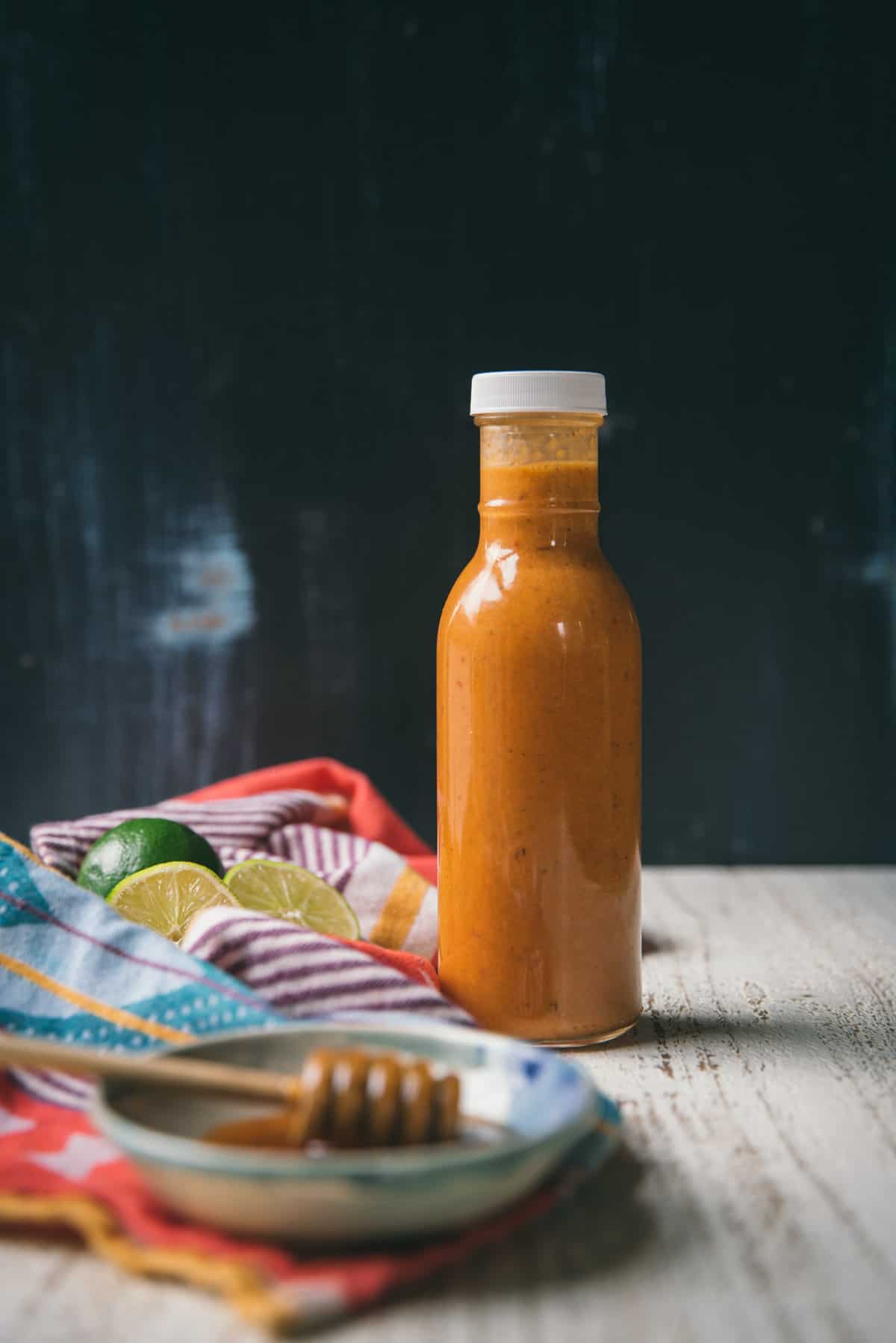 chipotle dressing in a bottle with blue background